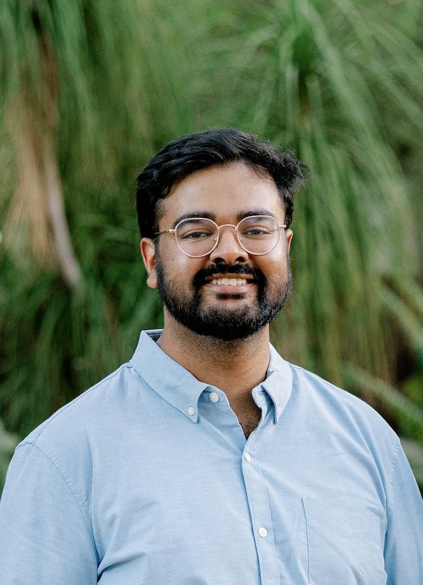 Jerrin Mathew, smiling, in a light blue shirt